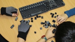 Kinder bauen bei einer alten Tastatur die Tasten aus