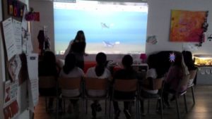 Mädchen betrachten selbst gestaltete virtuelle Welt an Leinwand