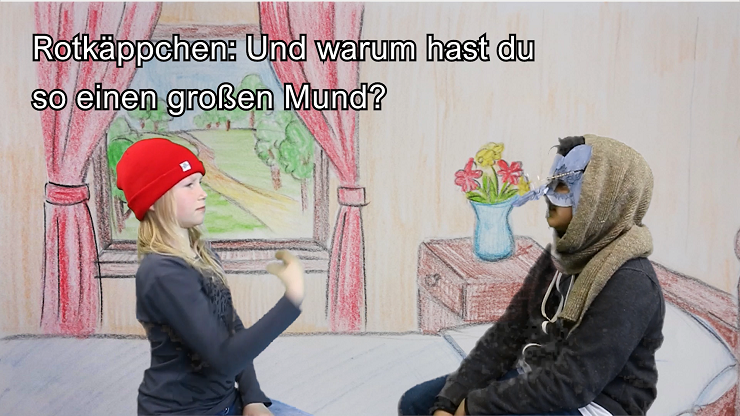 Rotkäppchen gebärdet dem als Großvater verkleideten Wolf: Und warum hast du so einen großen Mund?