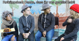 Rotkäppchen, Großvater und die zwei Jäger. Rotäppchen gebärdet: "Danke dass ihr uns geholfen habt"